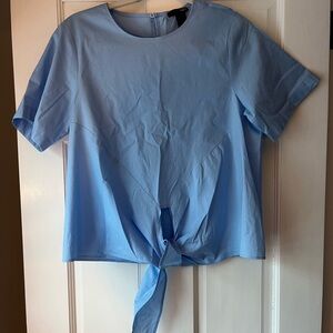 Blue crew neck short sleeve blouse with tie front and boxy style